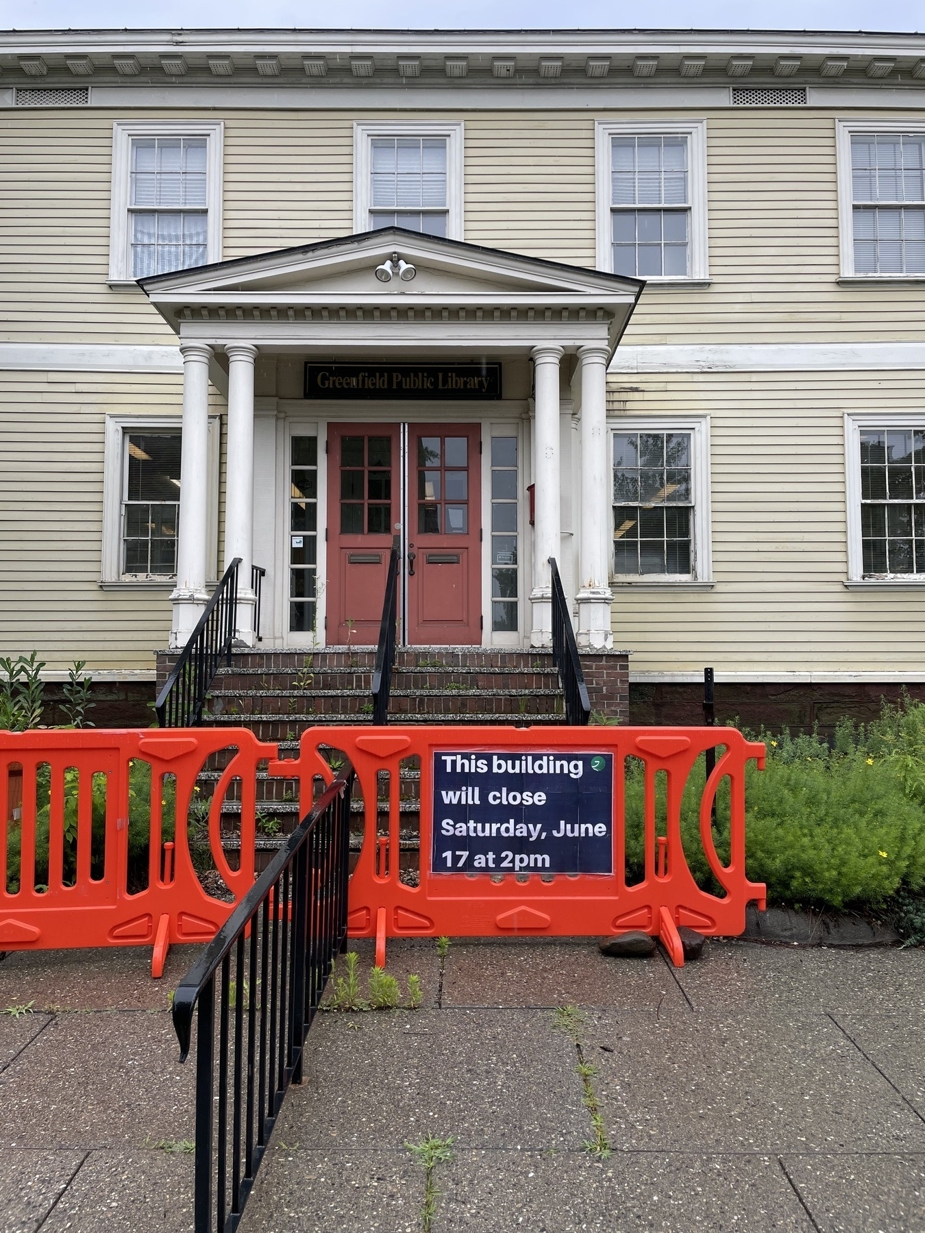 Building closing sogn in front of the old Greenfield Public Library